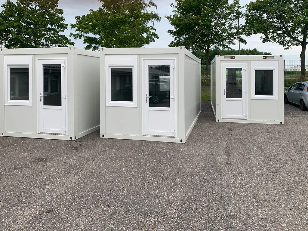20ft flat pack container offices lined up in the yard — actual unit photo