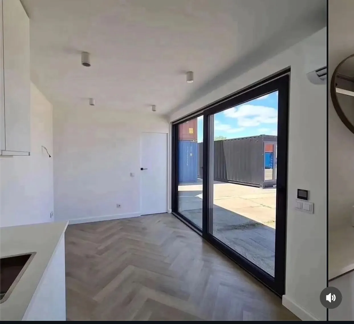 40ft container home open-plan kitchen and living area with sliding glass wall